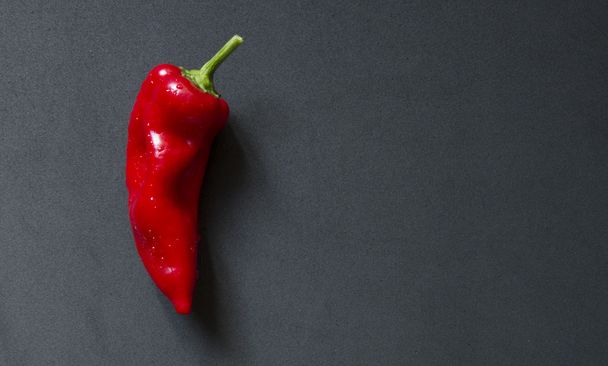 red pepper on black board - Фото, зображення