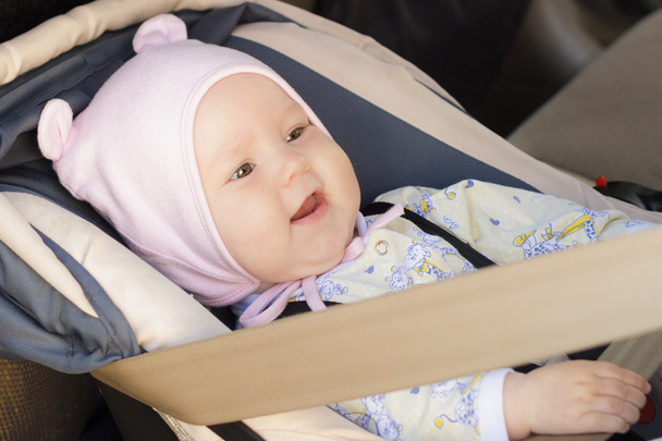 little newborn baby girl rests in the car seat - Foto, imagen