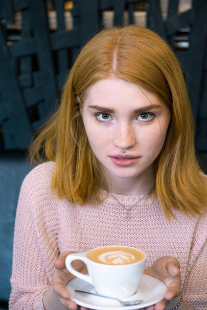 Girl holding a cup of coffee - Zdjęcie, obraz