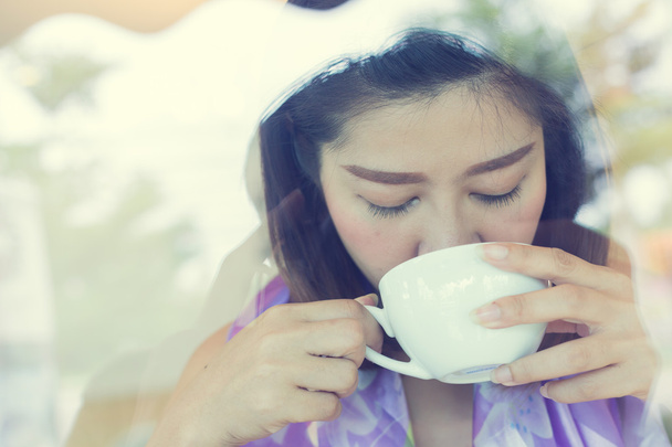 female drinking hot coffee in cafe - Photo, Image