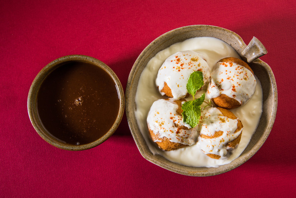 indian dahi vada or dahi bhalla, served in ceramic bowl served with tamarind or imli chutney - Photo, Image
