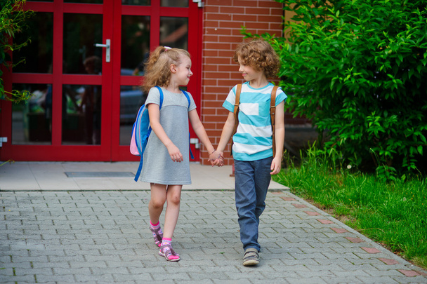 Boy and girlie go to school having joined hands. - Φωτογραφία, εικόνα