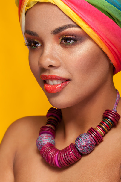 Afro american young woman wearing a turban and necklace - Фото, зображення