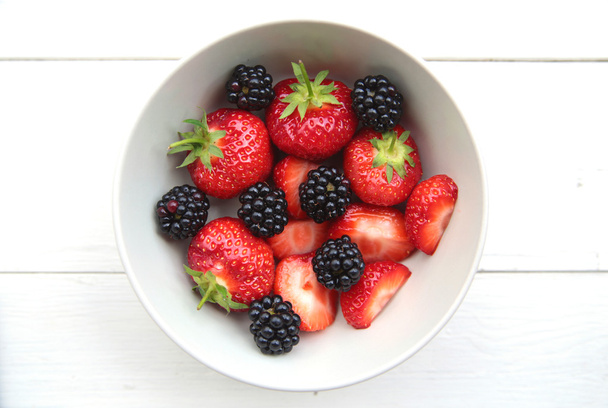 a bowl of delicate strawberries and blackberries - Photo, Image