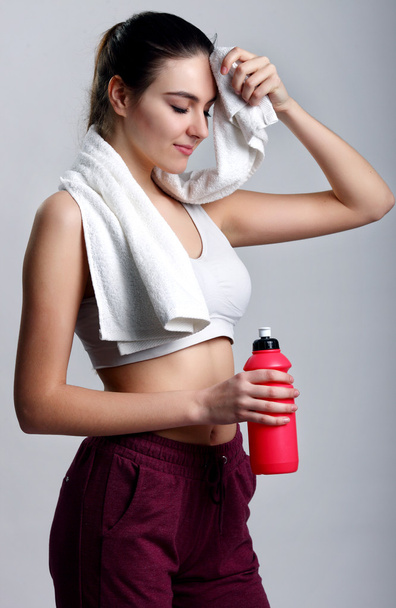 Young healthy fitness woman with towel and water - Fotografie, Obrázek