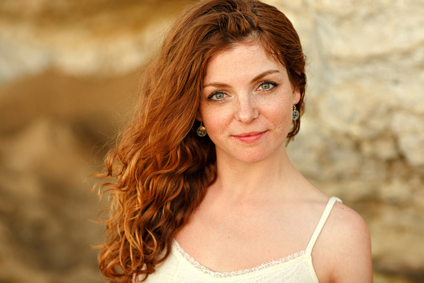 The red-haired sensual girl with freckles on a background of yel - Φωτογραφία, εικόνα