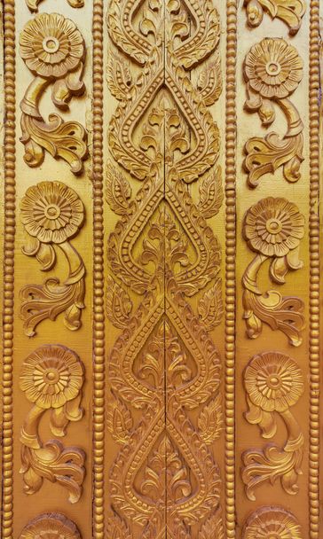 Wood carving on the wall in Myanmar. Myanmar carving on golden wall. - Photo, Image