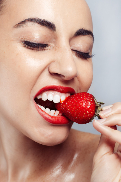 Sexy Woman wearing Eating Strawberry. - 写真・画像