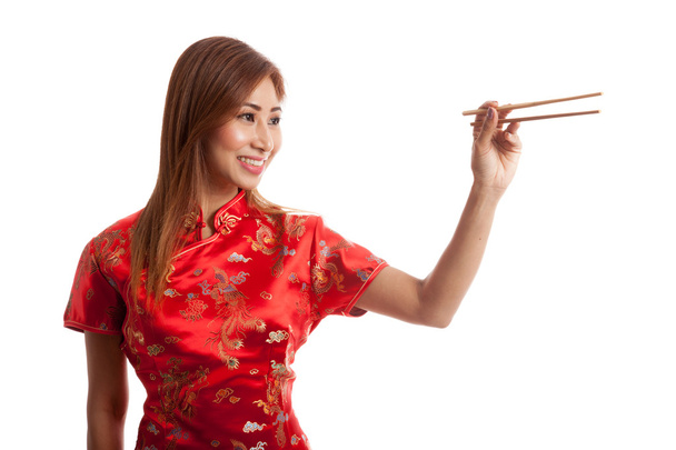 Asian girl in chinese cheongsam dress with  chopsticks - Фото, изображение