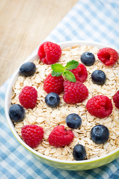 Oatmeal porridge with berries. Raspberries and blueberries. - Valokuva, kuva