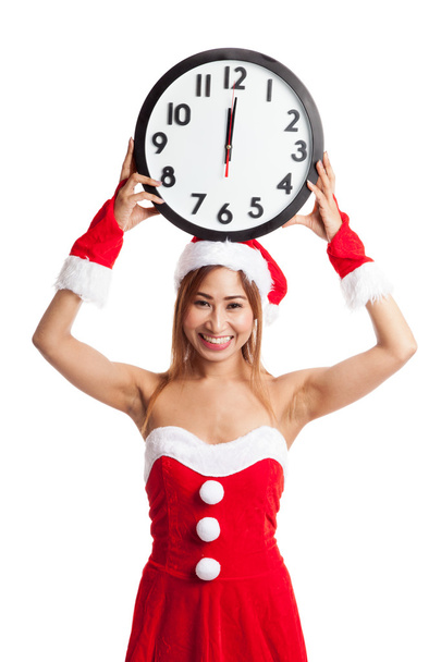 Asian Christmas girl in Santa Claus clothes and clock at midnigh - 写真・画像