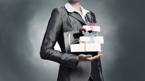 Businesswoman receiving or presenting gifts . Mixed media - Φωτογραφία, εικόνα