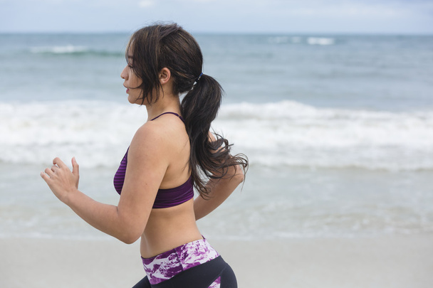 Kobiece biegacza jogging podczas treningu na świeżym powietrzu na plaży - Zdjęcie, obraz