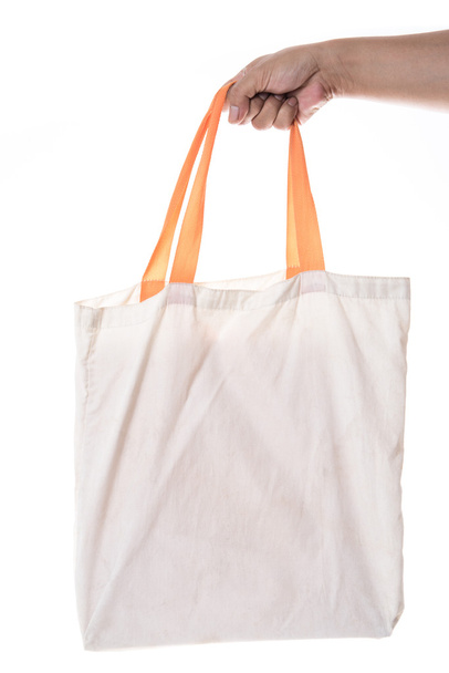 Hand holding cotton eco bag on white background - Photo, Image
