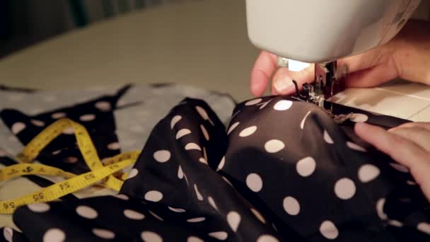 Close up shot of a tailor behind a sewing machine - Footage, Video