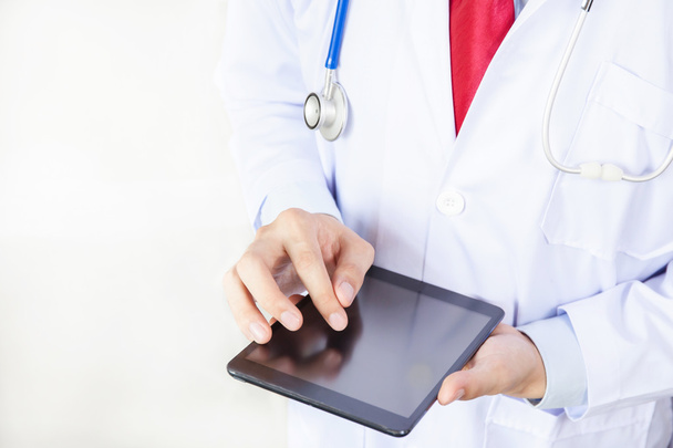 Doctor using tablet in white isolated background - Valokuva, kuva