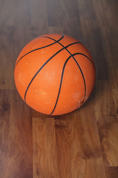 Basketball ball over wooden floor - Photo, Image
