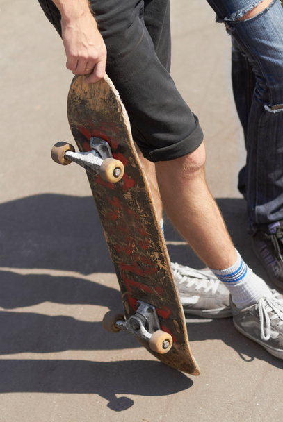Skater holding a board - Foto, Imagen