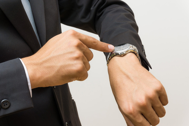 I waiting for you, Young business man looking at watch over white background - Photo, Image