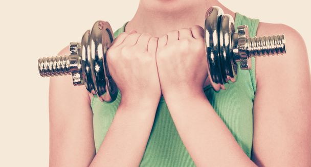 Woman exercising with dumbbells lifting weights  - Fotó, kép