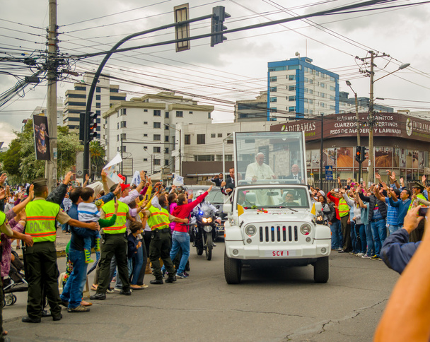 QUITO, ECUADOR - JULY 7, 2015: Ecuadorian people trying to touch and say welcome to pope Francisco, streets crowded - 写真・画像