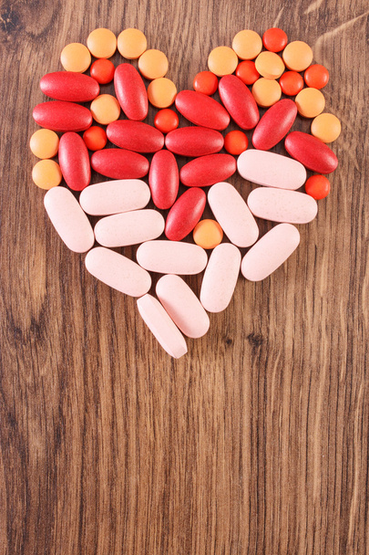 Heart shaped colorful medical pills and capsules, health care concept, copy space for text - Foto, immagini