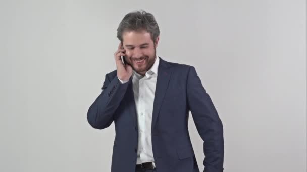 Businessman in suit talking on a mobile phone - Felvétel, videó