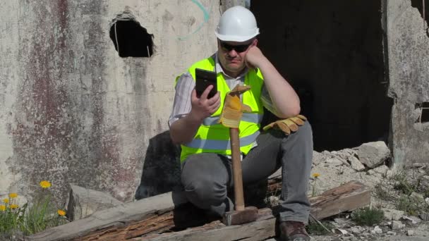 Construction worker thinking and using tablet PC  - Footage, Video