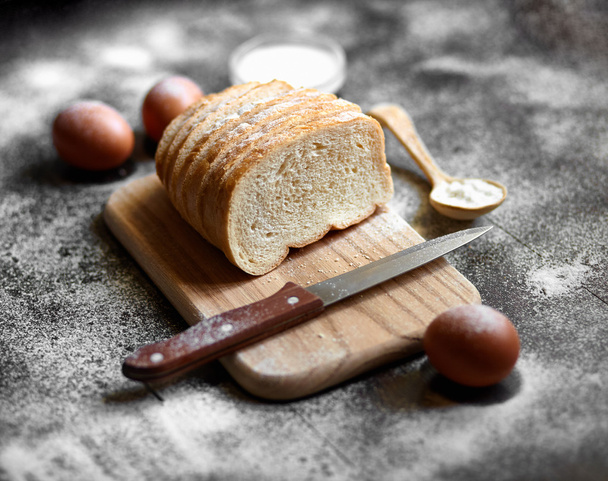 Ingredients for the preparation of bakery products. Bread, flour, eggs and cherry tomatoes. - Photo, Image