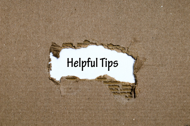The word helpful tips appearing behind torn paper - Photo, Image