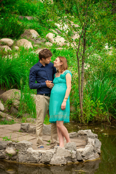 Young pregnant woman with young man outdoor - Photo, Image