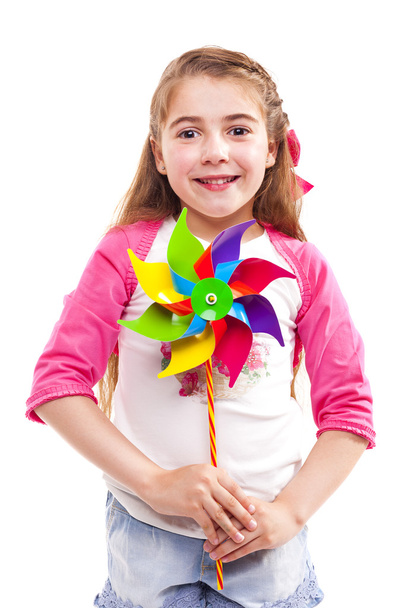 girl holding a colorful toy windmill - Zdjęcie, obraz