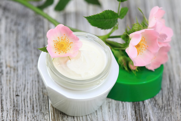 Face and body cream  with dog rose, also known wild rose, Rosa canina - Photo, Image