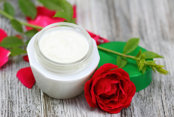 Face and body cream  with red rose. - Photo, Image