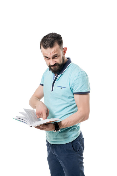 Bearded man looks at camera while shows the book - Photo, Image