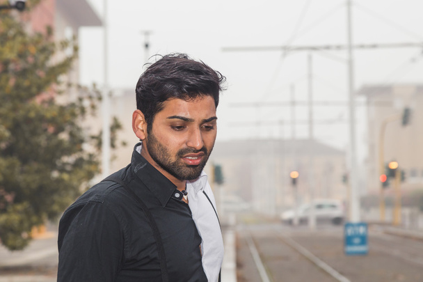 Handsome Indian man posing in an urban context - Photo, image