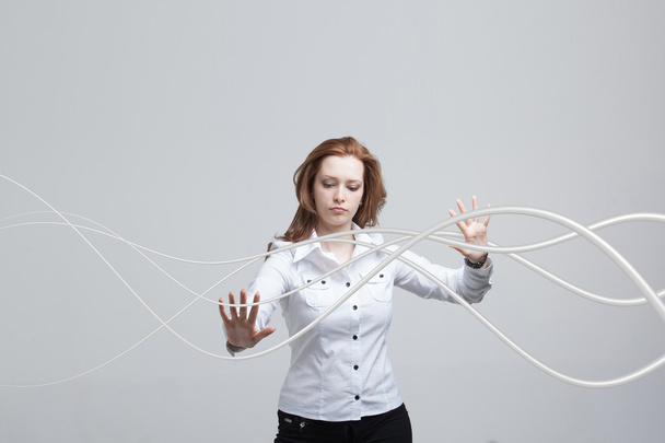 Woman with electrical cables or wires, curved lines - Foto, Imagen