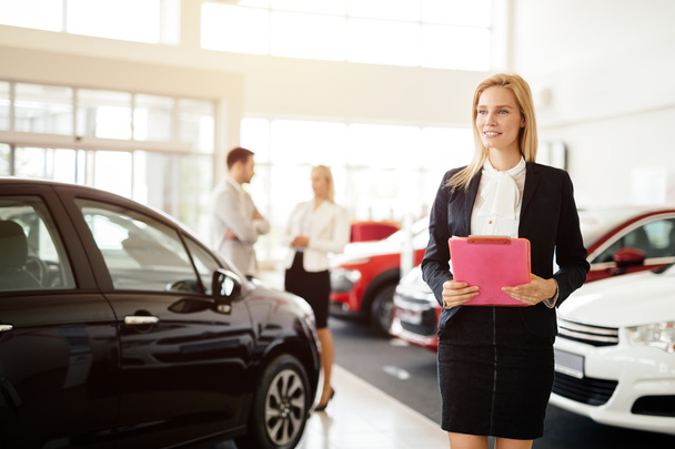 Professional salesperson in car dealership - Foto, Imagen