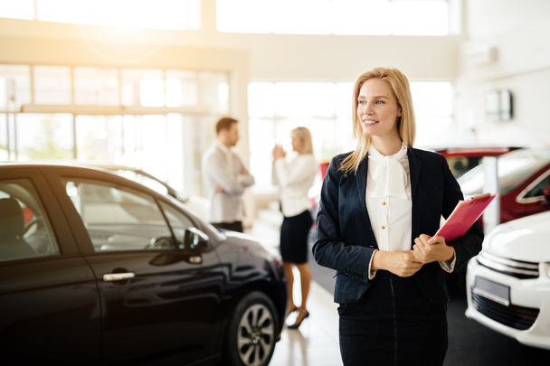Salesperson working at car dealership - Photo, Image