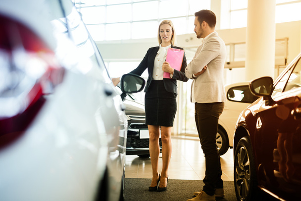 Car salesperson assisting customer - Foto, Imagem