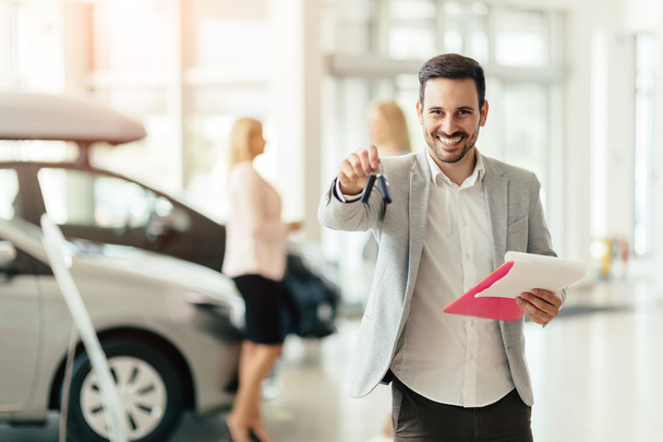 Happy businesswoman holding key from car - Photo, image