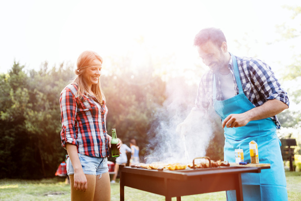 Friends camping and having a barbecue - 写真・画像