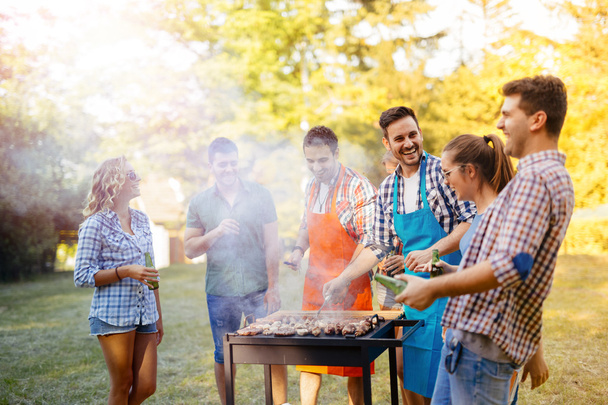 Friends having a barbecue party in nature - Foto, Imagen