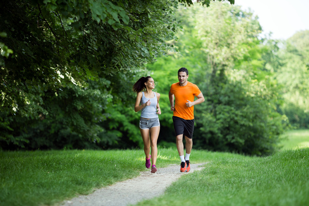 Athletic couple jogging in nature - Foto, imagen