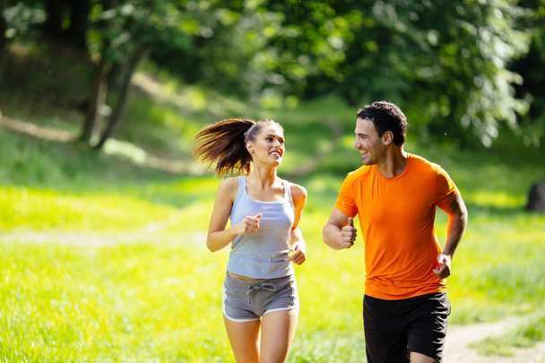 Healthy couple jogging in nature - Foto, imagen