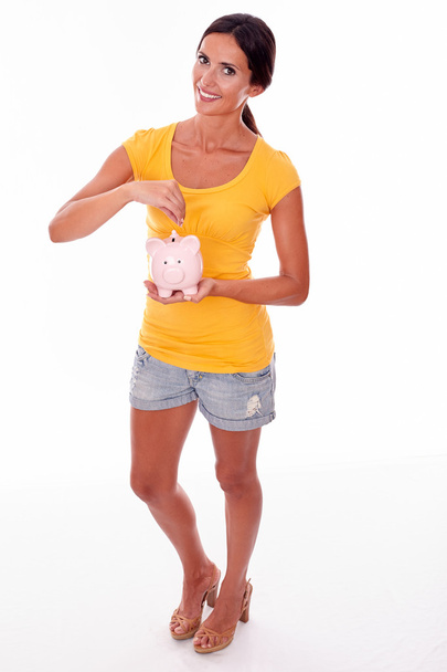 young brunette woman with piggy bank - Fotoğraf, Görsel