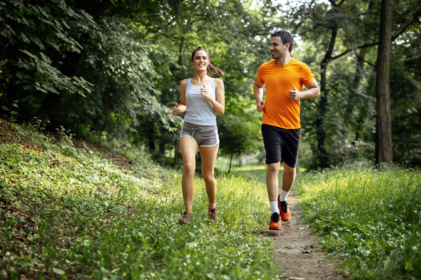 Healthy couple jogging in nature - Photo, image