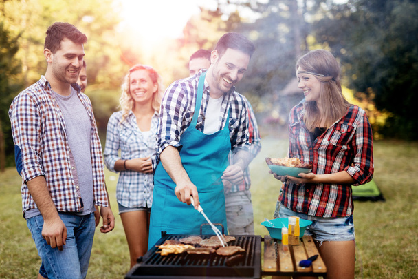 Friends camping and having a barbecue - Photo, Image