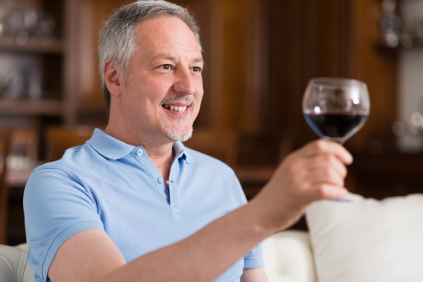 man enjoying glass of red wine  - Valokuva, kuva