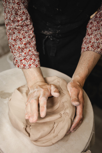 Potter master mashing the clay - Photo, Image
